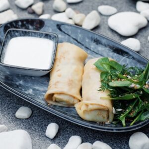 Pancakes with chicken and mushrooms, mixed greens and sour cream